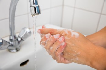 Woman Applying Soap On The Hand Near Basin
